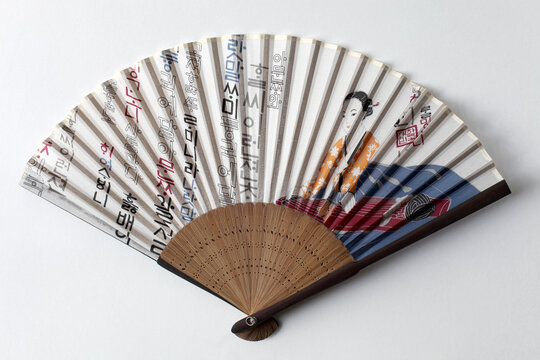 A buchae or traditional Korean fan which is often highly decorated.