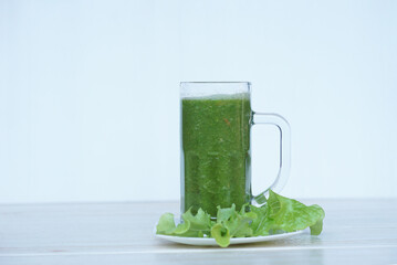 Green smoothie organic herbal vegetables in glass. Concept, healthy beverage for health. Well being and weight loss menu. Homemade refreshing drinks. High fibers, detox.      
