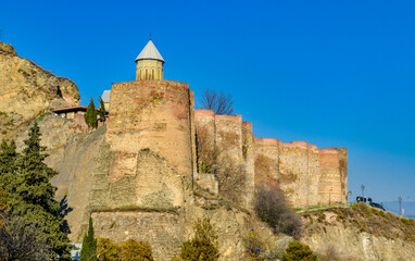 Fototapeta premium Narikala fortress ruins and Saint Nicholas's Orthodox Church scenic view from Botanical Garden (Tbilisi, Georgia)