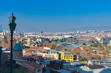 Dzveli Tbilisi district and Bridge of Peace panoramic view from Narikala fortress walk  - obrazy, fototapety, plakaty