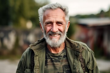 Portrait of an elderly man with a beard on a blurred background