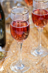 glasses of rose champagne on sparkling golden cloth