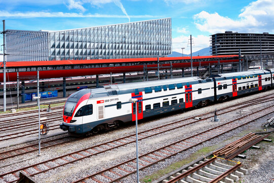 Geneva, Switzerland, Europe - Stadler KISS Swiss - Electric multiple unit train at Geneve-Secheron railway station, in background  JTI Building - headquarters of Japan Tobacco International 
