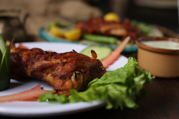grilled chicken serve in plate with salad leaf, cucumber restaurant style. 