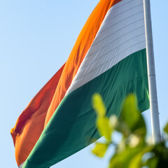 India flag flying high at Connaught Place with pride in blue sky, India flag fluttering, Indian...