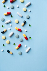 Different pills on color background, flat lay