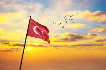 Waving flag of Turkey against the background of a sunset or sunrise. Turkey flag for Independence Day. The symbol of the state on wavy fabric. - obrazy, fototapety, plakaty