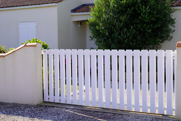 modern white gate pvc plastic portal entrance with blades of suburbs house facade