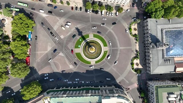 Aerial view of Freedom Square and statue of George the Victorious, who stands on a column in Freedom Square. in Tbilisi, Georgia. Traffic of cars at the roundabout intersection. City view