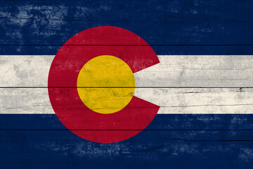 Colorado State flag on a wooden surface. Banner of the grunge Colorado State flag.