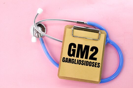 stethoscope and pink board with the word GM2 gangliosidoses