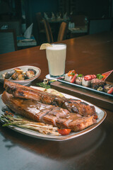 Photobook of grilled meat on a restaurant table.