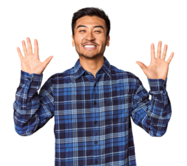 Young Chinese man in studio background showing number ten with hands.