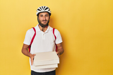 Hispanic delivery man with pizzas and backpack