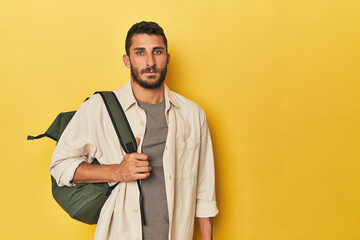 Young Hispanic man with travel backpack