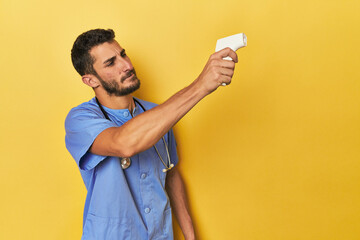 Young Hispanic nurse with a thermometer