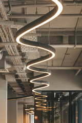 modern LED lighting by curved lamp in industrial interior