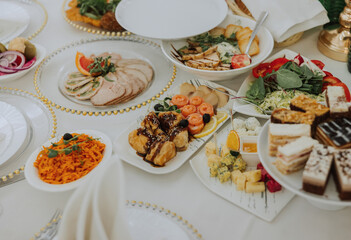Top view of a beautifully decorated table with delicious food. Everything is ready for lunch or dinner with delicious snacks and a cozy atmosphere.