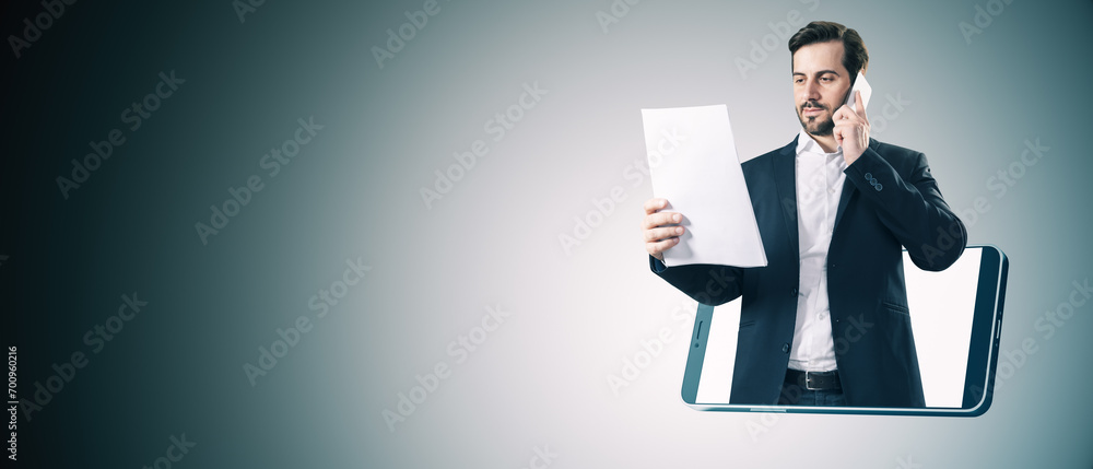 Aufkleber smiling young european businessman looking at document inside smartphone on gray background with moc