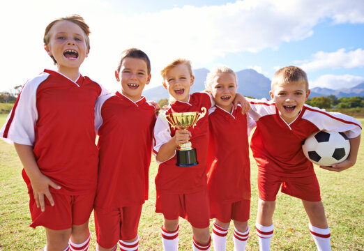 Victory, soccer team and children with cup, boys and girls with pride, support or proud. Achievement, sports and friendship, together and happy for win, ready for game and physical activity