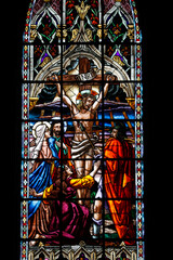 Basilica of the National Vow located in the historic center of Quito, Ecuador. Stained glass depicting a soldier piercing the side of Jesus as he hangs on the cross during his crucifixion.
