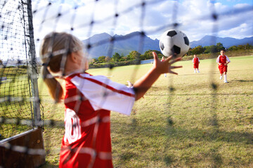 Girl, soccer and ball with goal keeper for save, match or game from scoring point on outdoor field. Team of football players playing together for sports, competition or training practice in nature