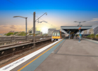 Commuter Train fast moving through a Station in Sydney NSW Australia locomotive electric light rail