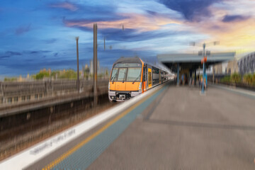 Commuter Train fast moving through a Station in Sydney NSW Australia locomotive electric light rail