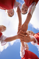 Hands, support and group of children on soccer team, team building and collaboration or huddle in...