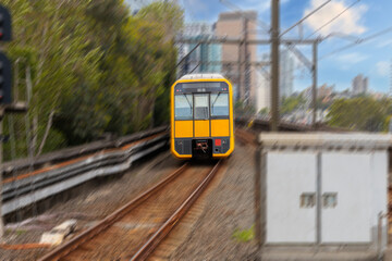 Commuter Train fast moving through a Station in Sydney NSW Australia locomotive electric light rail