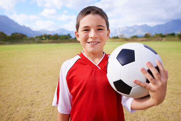 Child, portrait and soccer player on field, sports and confidence for match and game. Happy boy,...