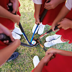 Children, hockey team and huddle above with ball on green grass for sports, match or game together....