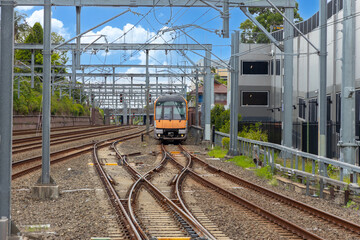 Commuter Train fast moving through a Station in Sydney NSW Australia locomotive electric light rail
