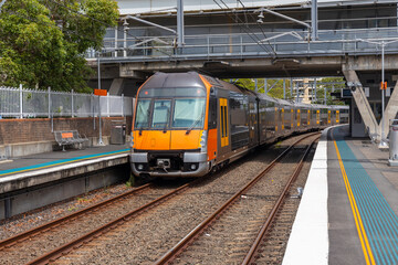Commuter Train fast moving through a Station in Sydney NSW Australia locomotive electric light rail - obrazy, fototapety, plakaty