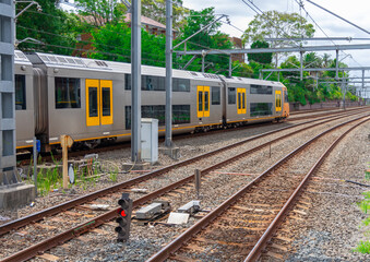 Commuter Train fast moving through a Station in Sydney NSW Australia locomotive electric light rail