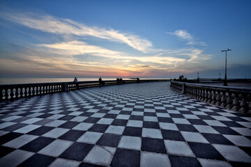 Fototapeta na wymiar The beautiful sunsets and color contrasts of the famous Terrazza Mascagni in Livorno