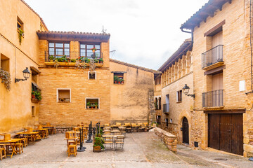 Beautiful square by Rafael Ayerbe. Old Plaza Mayor of the Pyrenean town of Alquezar, Huesca, Spain