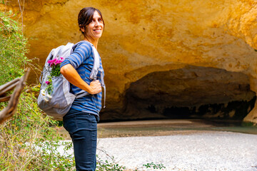 Woman with backpack in the cave on the Vero River walkway path in Alquezar. Huesca Pyrenees