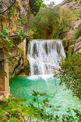Beautiful landscape in the waterfalls next to the path on the Vero River walkways in Alquezar. Pyrenees of Huesca, vertical photo