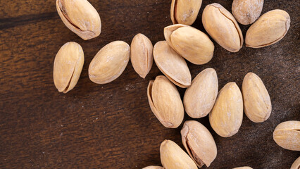 Pistachios on a wooden background, top view, close-up