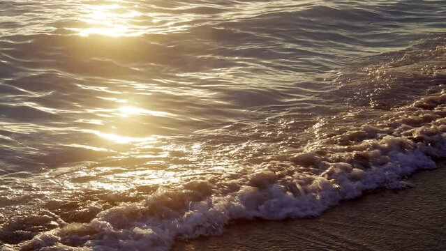 Slow motion of ocean waves on a beach at sunset. 4k, h265, 30 fps, 4:2:2 10 bit (BT709).