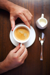 Cropped shot of young businessman with cup of coffee