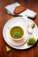 Delicious broccoli soup on table