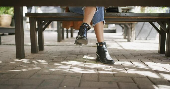 Woman, waiting and feet in restaurant, shoes and time for date, impatient and outdoors. Alone, anxious and person on table, awkward and tapping on ground, body language and unknown with legs