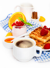 Delicious breakfast with fresh coffee, fresh waffles and fruits
