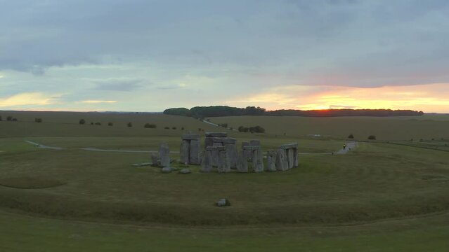 Stonehenge, England - wide tracking around stone circle at sunset