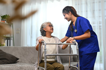 Caring healthcare worker talking while visiting senior woman patient at home. Healthcare concept.