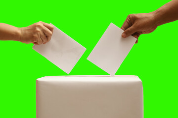 hand holding the ballot into the ballot box. election day concept isolated green screen background.