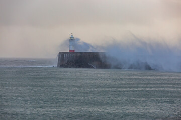 Fototapeta premium Newhaven lighthouse on the Sussex coast, during a winter storm