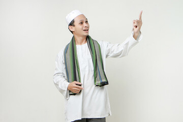happy asian muslim man poitning finger gesture. People religious Islam lifestyle concept. celebration Ramadan and ied Mubarak. on isolated background.